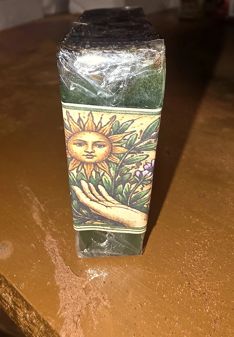 Close-up of the Energy Cleansing soap band, with its sun, leaves and open-hand artwork.