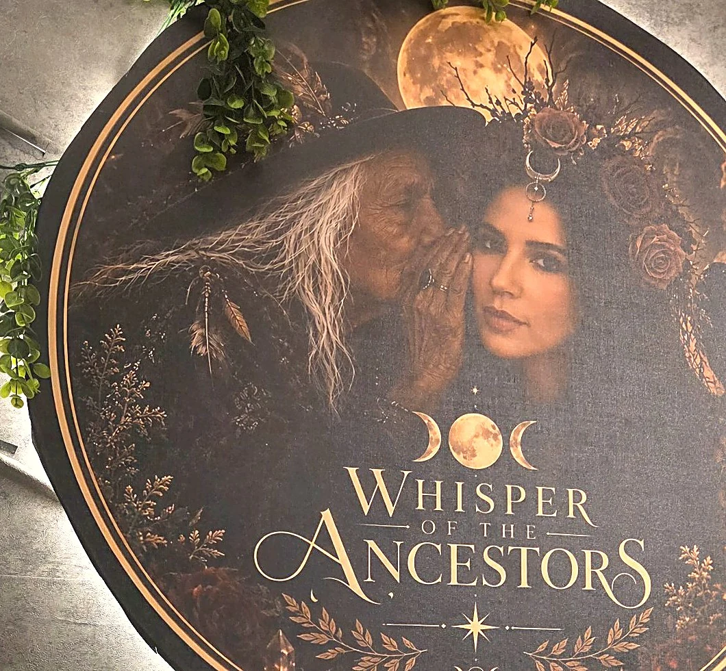 The studio's signature banner artwork: an elder leans close to whisper to Laiany, framed by moons, flowers and the Whisper of the Ancestors name.