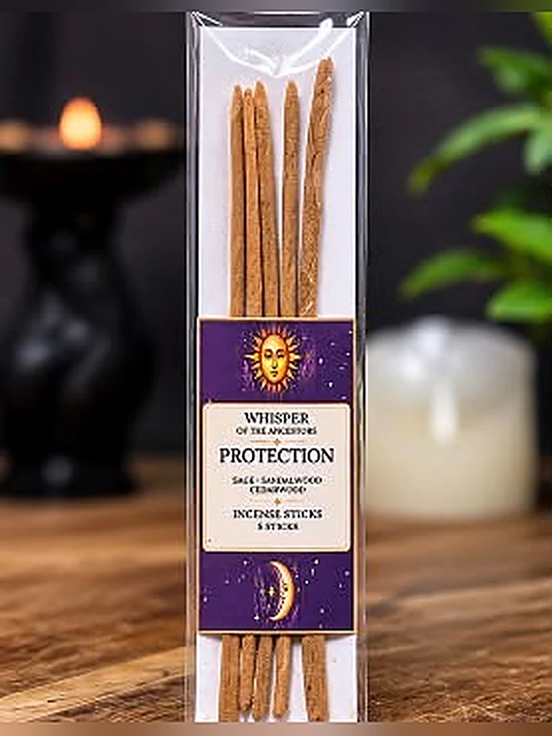 Package of five Protection incense sticks standing upright in a clear sleeve on a white backing card, wrapped with a purple and cream label printed with a sun and crescent moon