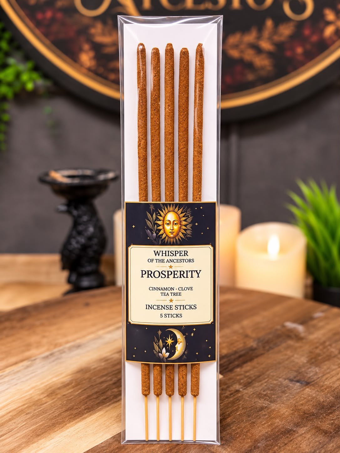 Package of five Prosperity incense sticks in a clear sleeve on a white backing card, wrapped with a black and cream label printed with a golden sun and crescent moon