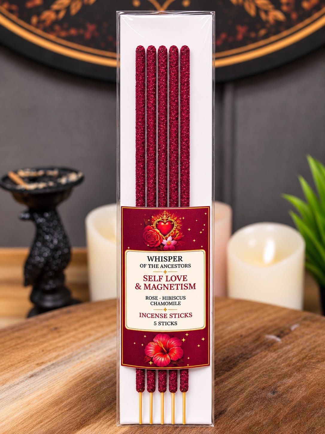 Package of five Self Love & Magnetism incense sticks in deep burgundy, in a clear sleeve with a sacred-heart label, standing upright on a wooden table