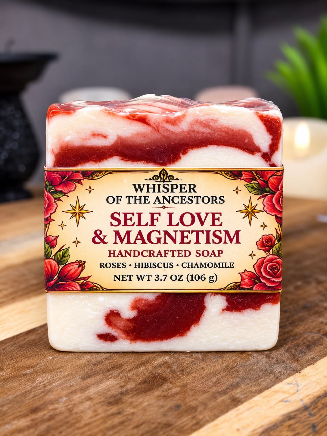 Self Love & Magnetism handcrafted soap bar swirled cream and deep crimson, wrapped in clear film with a cream paper band printed with red hibiscus